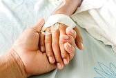 34753824-mother-holding-child-s-hand-who-fever-patients-have-iv-tube.jpg